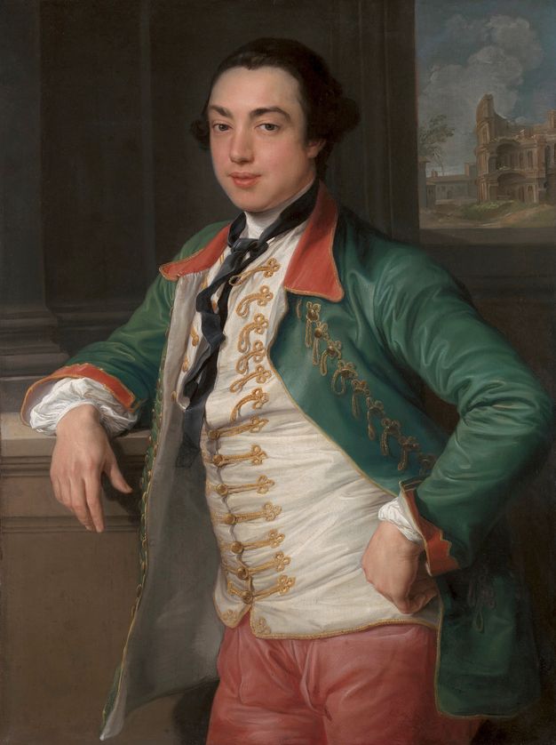Painting. Shown from the thighs up, a pale-skinned, clean-shaven man with dark hair curling over his ears stands with one arm resting on a ledge and the other fist planted on his hip. He looks at us with dark eyes under black brows, and his full pink lips are parted. He wears a fern-green jacket over a white vest, and carnation-pink breeches.